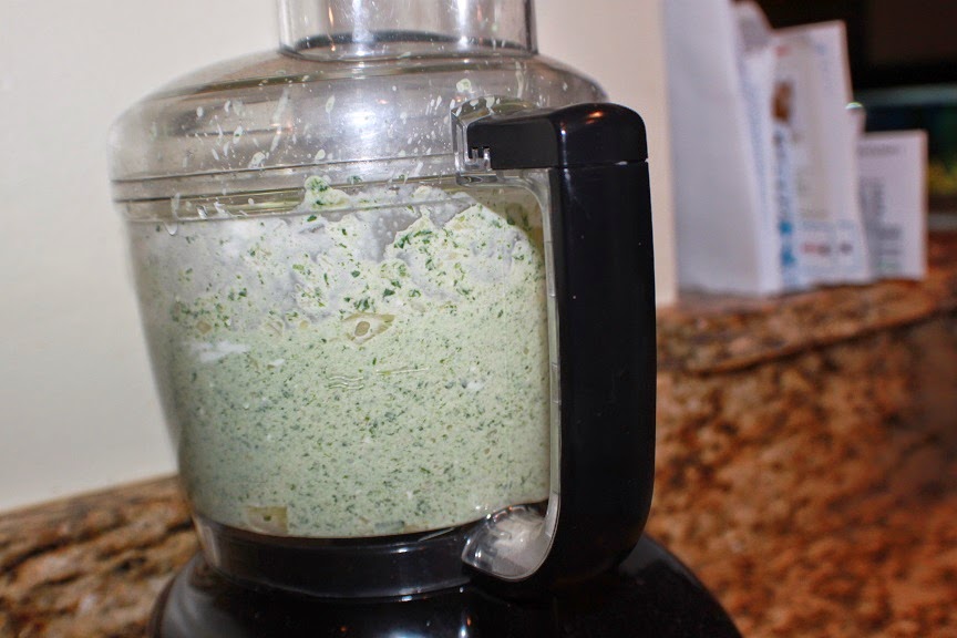 this is a food processor with ingredients in it to make spinach and artichoke baked dip