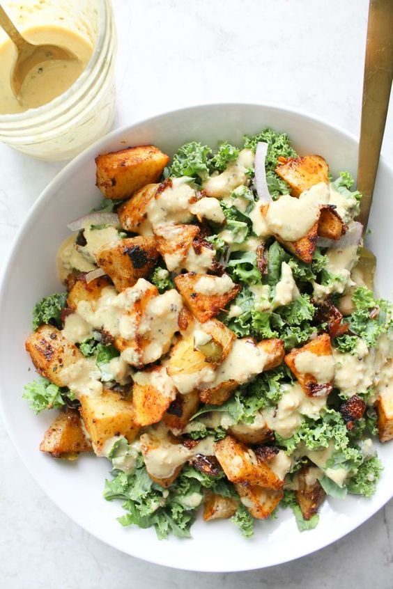 These Spicy Potato Kale Bowls with Mustard Tahini Dressing are the perfect Fall meal. Crispy potatoes, red onion, marinated kale and a delicious creamy dressing. Simple and healthy.