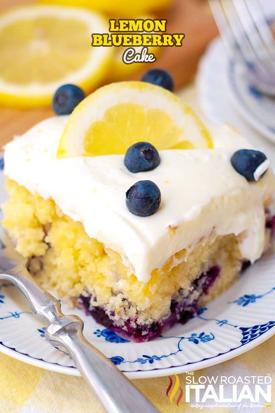 slice of Lemon Blueberry Cake with cream cheese frosting and fresh blueberries on a plate