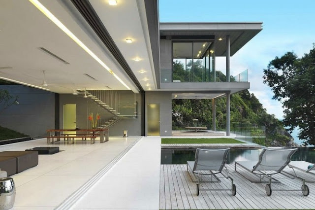 Photo of modern villa interiors as seen from the terrace through the large opening on the house