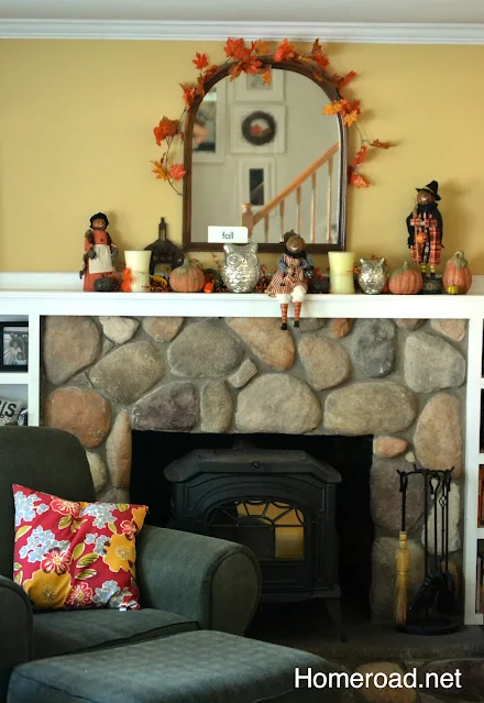 Fireplace with chair and fall decorated mantel.
