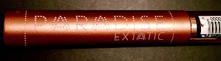 A long elongated cylindrical gold tube with Paradise engraved into the tube on a bright background 