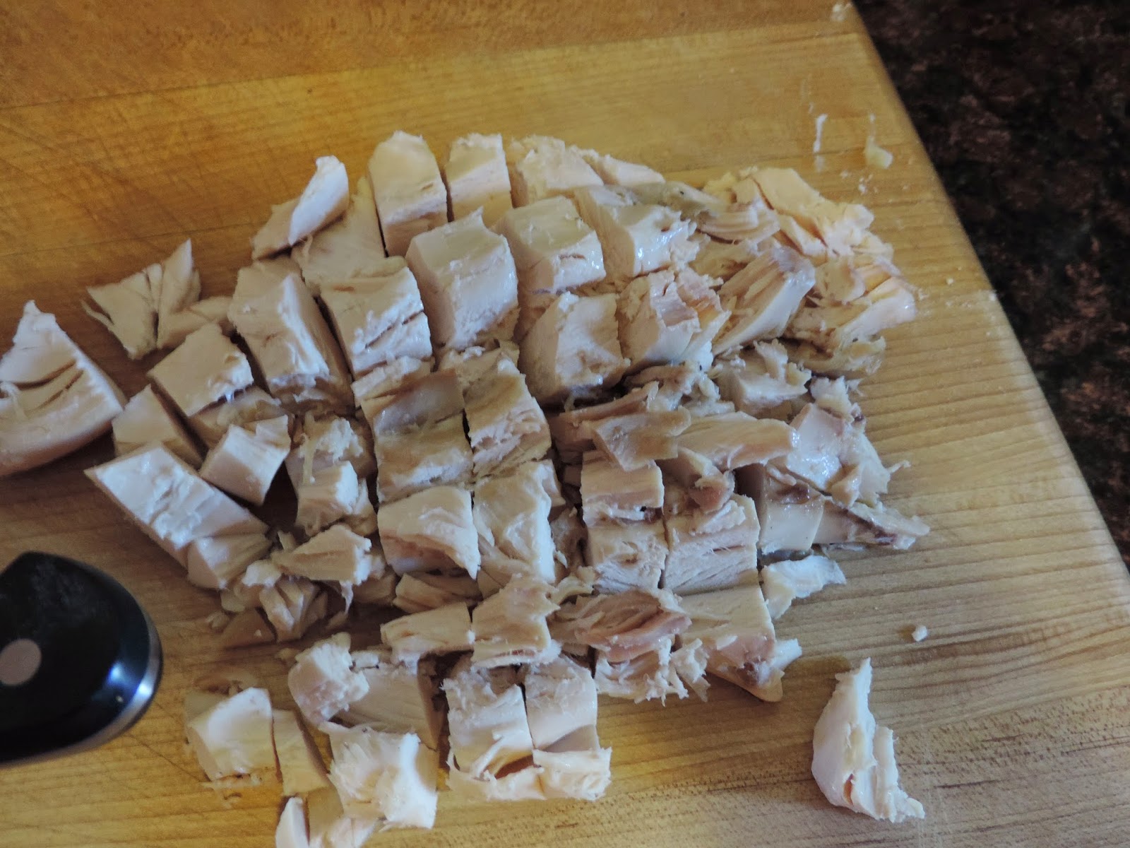 Diced chicken on the cutting board.