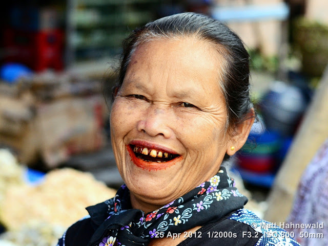 people, Batak woman, street portrait, Indonesia, Sumatra, Lake Toba, betel nut, betel quid, areca nut, sirih, paan, chewing tobacco, red coloured salivation, red stained teeth