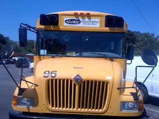Big yellow school bus parked at the beach, waiting to transport happy campers home after a fun day of camp at Aloha Beach Camp...where transportation's always free!