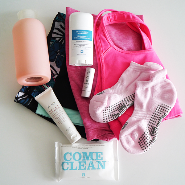 Fitness athleisure flatlay with Gapfit palm print leggings, pink sports bra, and pink Gapfit Breathe racerback tank folded up; pink Bar Method grippy socks; pink BKR water bottle; Fresh Soy Face Cleanser and Sugar Rose Lip Balm; Consonant Dealkalizing Deodorant and Come Clean cleansing cloths