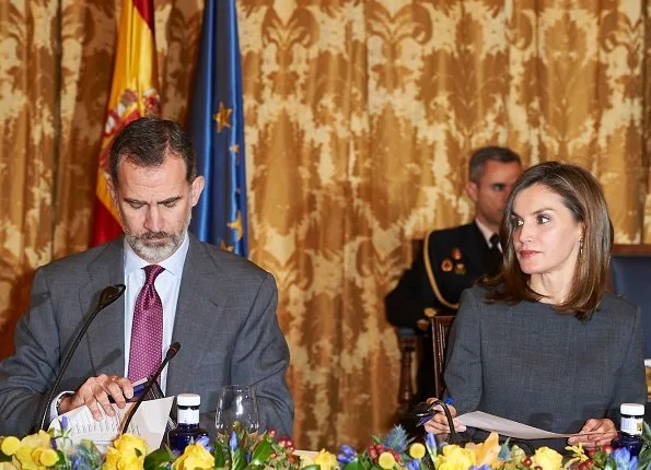 Queen Letizia carries Madmacarena python snake clutch bag. Uterque shoes, diamond jewellery earrings