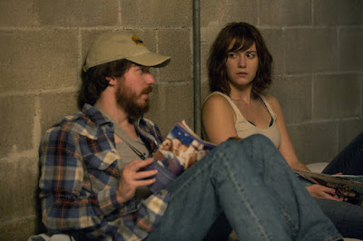 Movie still featuring Mary Elizabeth Winstead and John Gallagher Jr. from 10 Cloverfield Lane