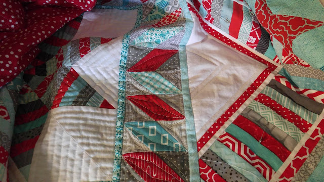 Red and aqua string star round robin quilt