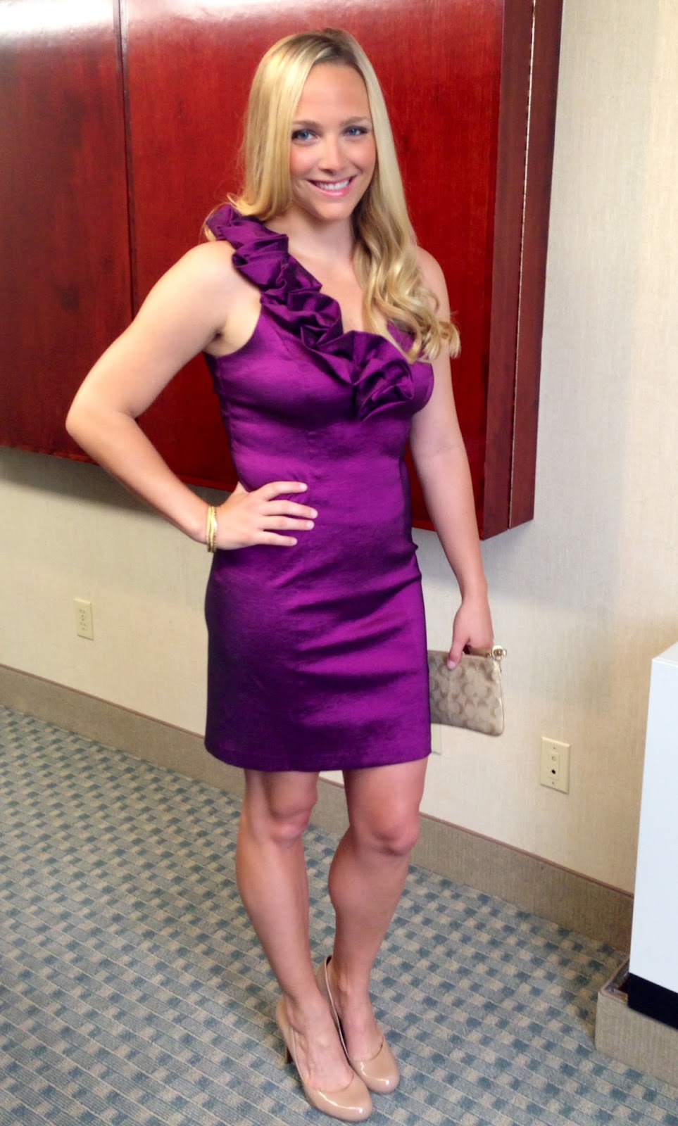 Casey poses in an elegant purple dress before attending a wedding. 