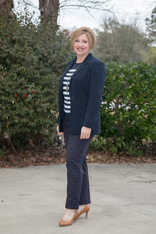 pattern mixing in an office outfit with plaid pants and striped sweater