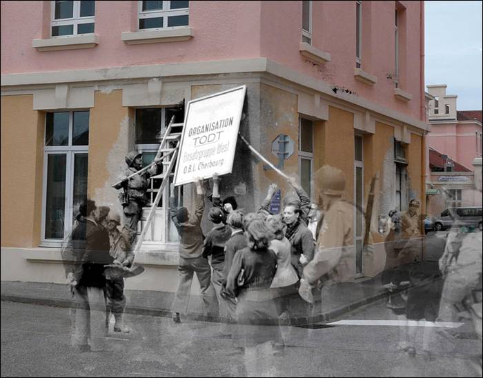“Rue Dom Pedro, civilians and American soldiers tear down the sign indicating the headquarters of the Todt organization in Cherbourg.”
