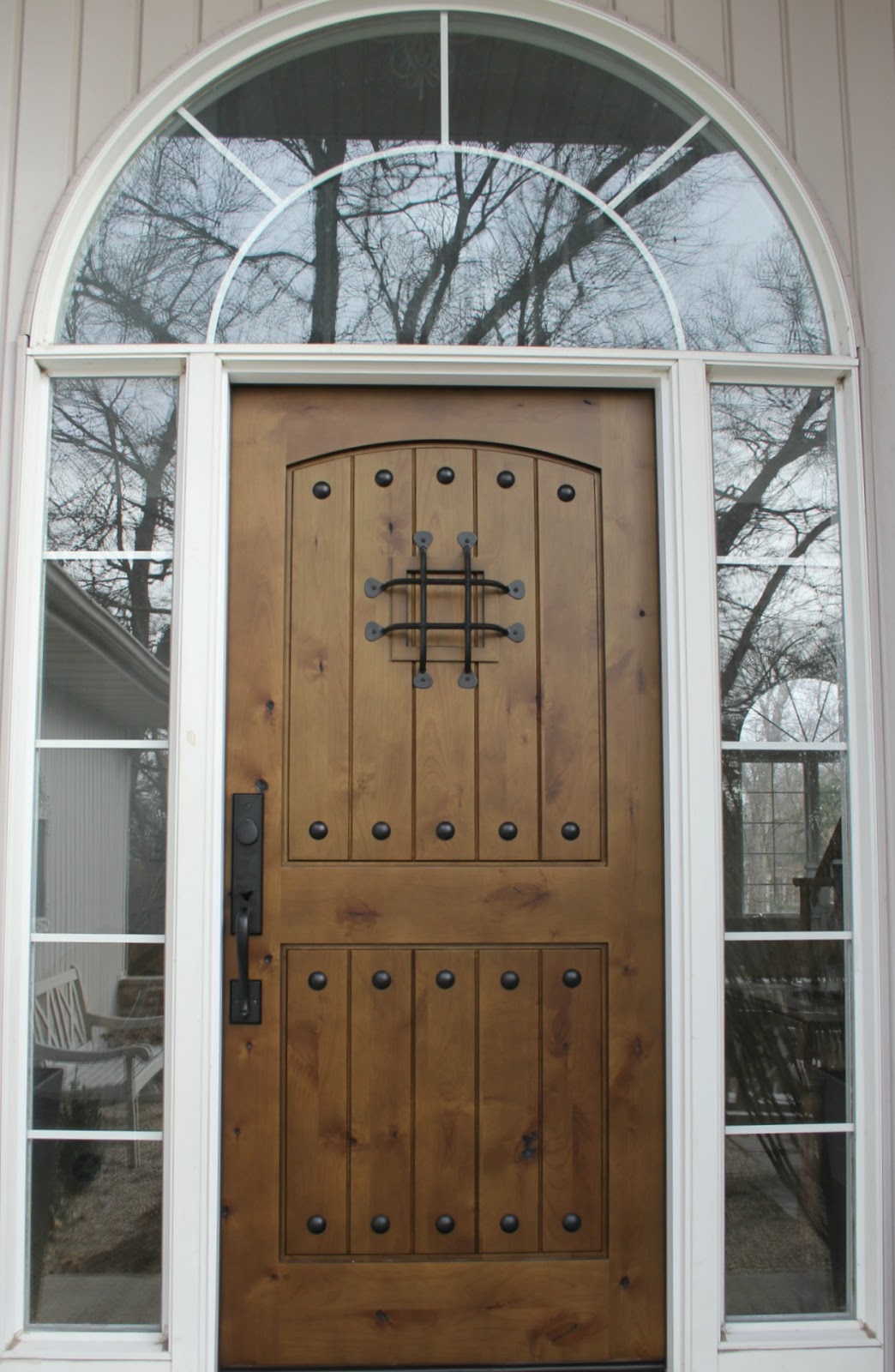 Rustic alder wood exterior door with speakeasy and handleset by Pacific Entries