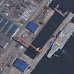 China's new aircraft carrier being parked by several tugs