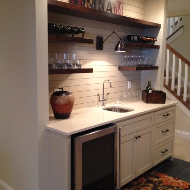 basement kitchenette with planked walls and shelves