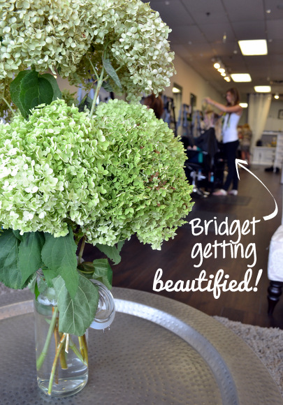 A gorgeous bunch of flowers with Bridget getting beautified in the background!