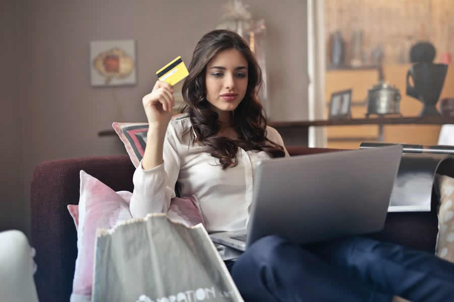 shopping online with credit card Woman shopping online on her laptop