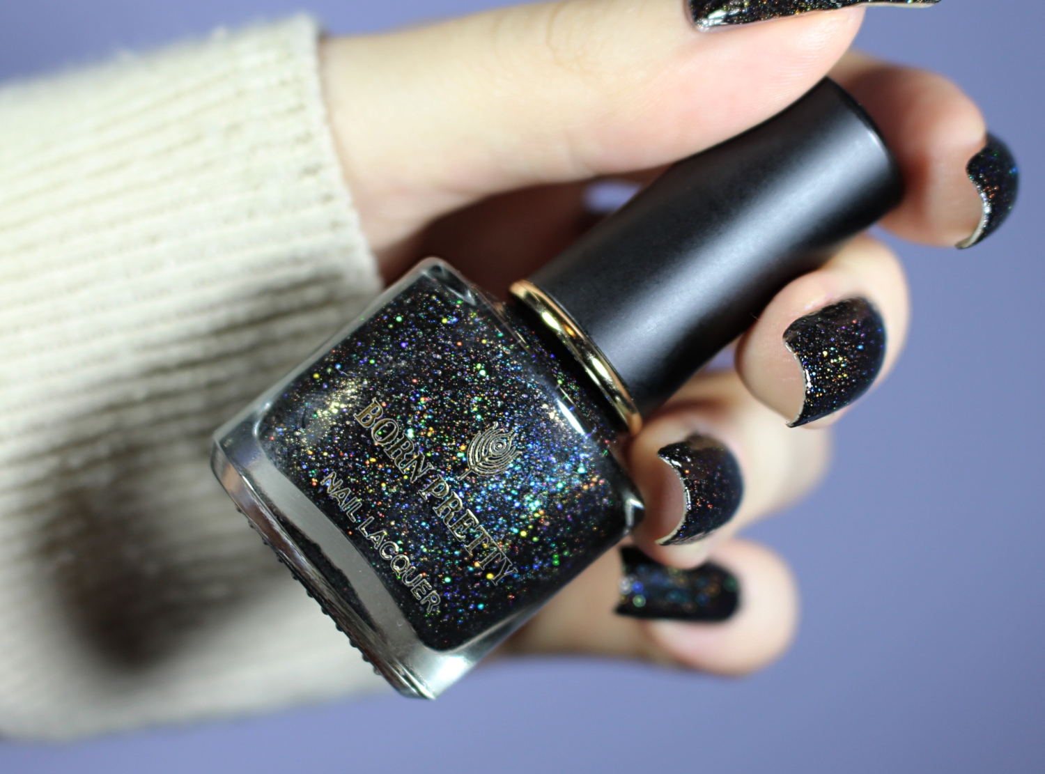 a close-up of a black, holographic nail look on long, natural nails inspired by the wiccan aesthetic