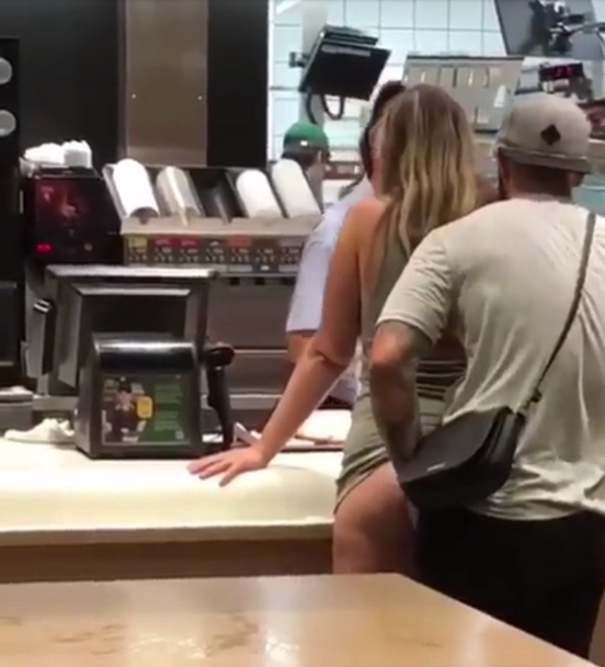 Bizarre moment raunchy couple 'have sex' at McDonald’s while orde...