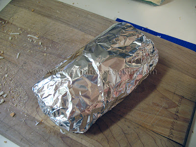 A photo of a grinder sandwich wrapped in foil.