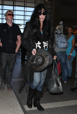 Youthful-looking Cher carrying a cowboy hat