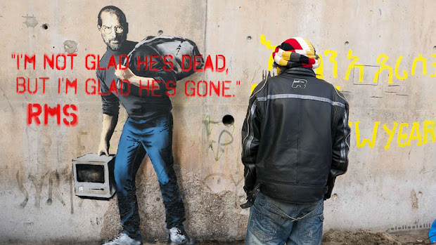 Banksy's dedication to Steve Jobs, defaced with the words of Richard Stallman: 'I'm not glad he's dead, but I'm glad he's gone.'