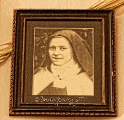 This picture is of a framed photo of  St. Thérèse de Lisieux.