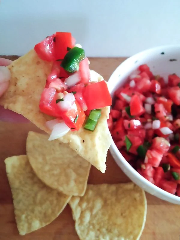 Easy and fresh Pico de Gallo is amazing with tortilla chips or as a garnish! Get the recipe at DIY beautify!