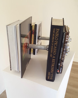 Silver chrome Barbell with books; Jeff Koons, Nicolas Machiavelli, Friedrich Nietzsche, Diogenes of Sinope, Sun Tzu, Baruch Spinoza, Socrates, Pascal ,Aristotle, Voltaire, Platon and Pablo Picasso, Andy Warlhol, Ai Weiwei,Jackson Pollock, Jean-Michel Basquiat.