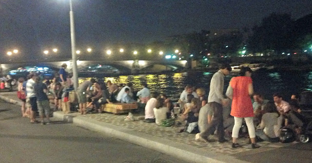 Hanging out on the riverfront at night in Paris