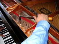 piano technician tuning piano strings