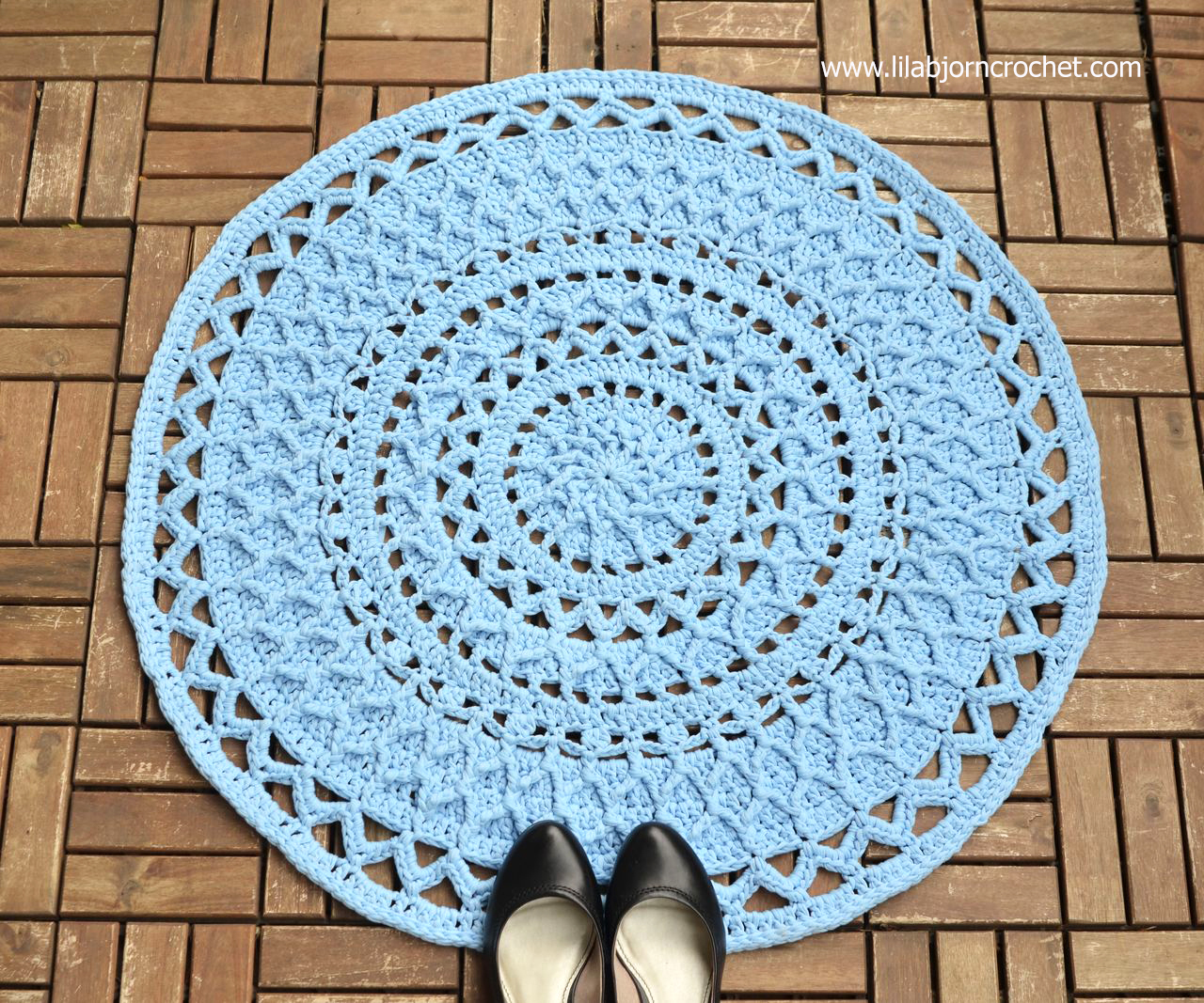 Andromeda Mandala Rug combines textured stitches with open, lace parts. The pattern can also be used for a doily when lighter yarns and small hook are used. Original design by Lilla Bjorn Crochet.