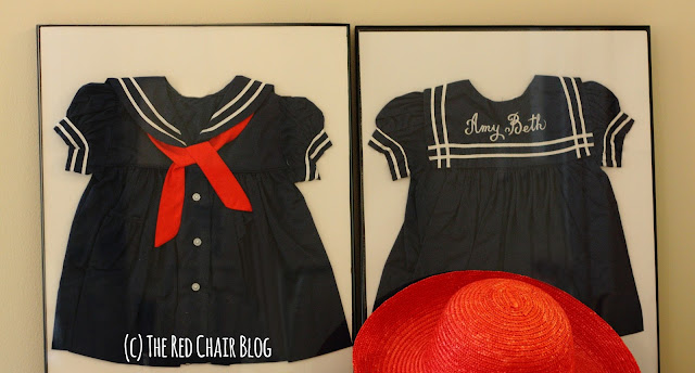 Framed baby dresses as 4th of July decor idea at The Red Chair Blog