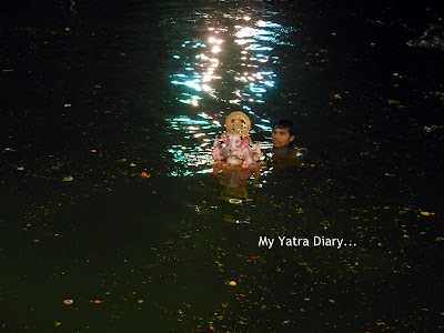 Ganesh Visarjan taking place in an artificial lake in Mumbai