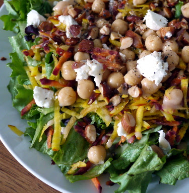 Spring salad with greens, shredded root veg, chickpeas, goat cheese, and almonds
