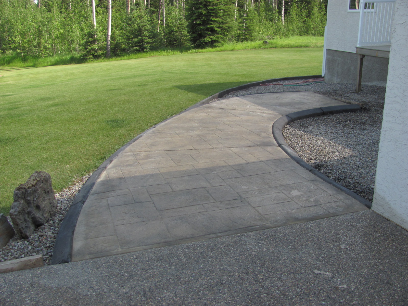 Sundre Concrete Works Landscape curbing with Ashlar stamped patio and walkway
