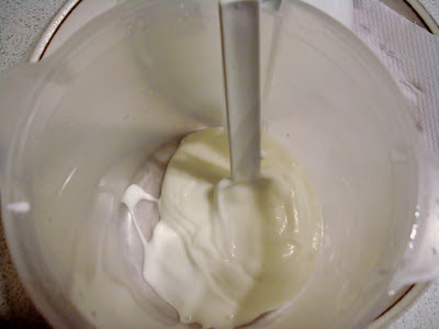 Spoon yogurt starter into the bowl of the yogurt maker