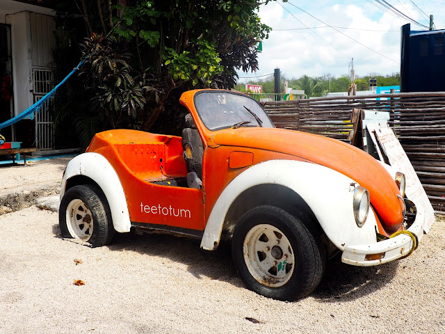 Bright orange mini bug car in Tulum, Mexico