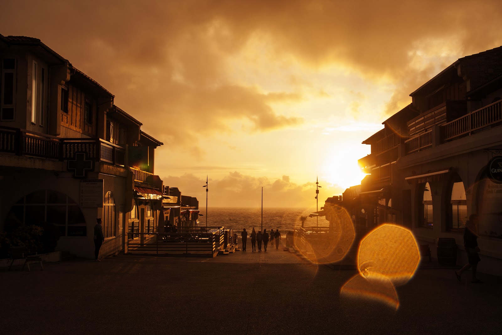 Sunset Behind Buildings Beside The Sea
