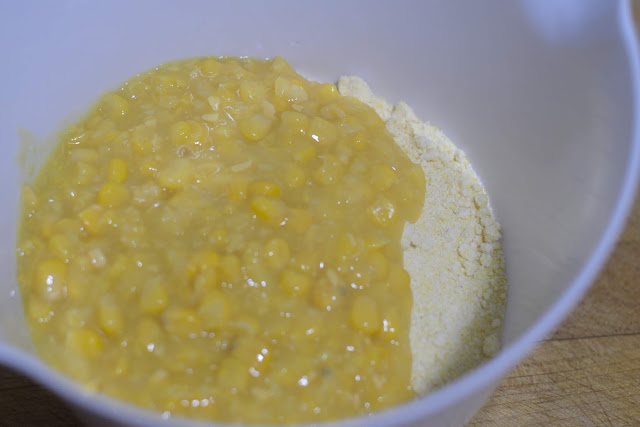 The cream of corn and Jiffy mix in a white mixing bowl. 