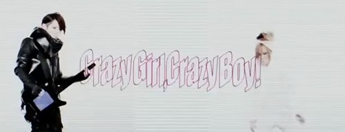 "Crazy Girl, Crazy Boy!" in pink outline while the boys perform.