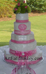 5 Tier white and pink fondant custom unique wedding cake design with ribbons, bow, and fresh flower