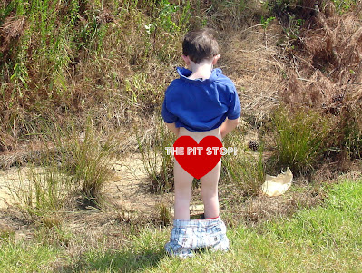 Little boy peeing in the woods