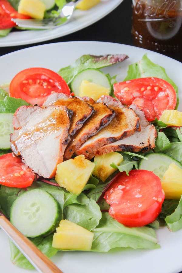 Juicy and flavorful pork, fresh pineapple and heirloom tomatoes are topped with a simple vinaigrette to create a hearty summer salad that the whole family will love!