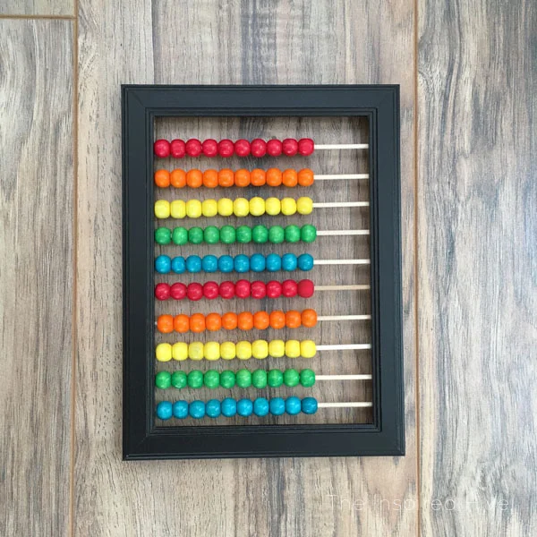 Such an easy craft! How to make your own DIY abacus wall decor. Great wall art idea for a kids room or playroom. #wallart
