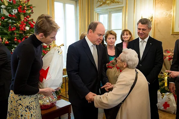 Prince Albert and princess Charlene of Monaco presented gifts to old people and children at "Red Cross" Monaco branch