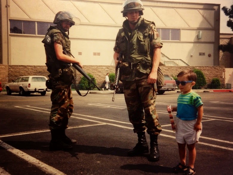 35 moments of violence that brought out incredible human compassion - a child poses beside national guard members during the la riots