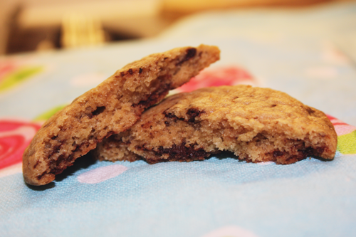 a chocolate chip cookie, broken in half, revealing oozing chocolate and gooey cookie on francescasophia.co.uk