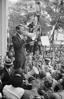 Bobby Kennedy with megaphone addressing hopeful and cheering crowd