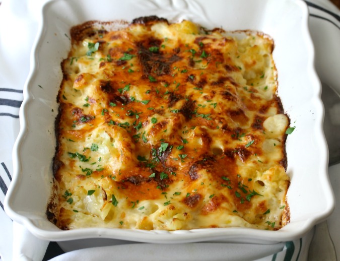 Cauliflower Cheese is a delicious dish of cauliflower baked in the cheesiest cheddar sauce until it is bubbly and golden.